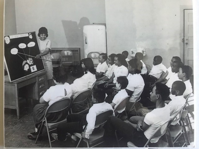 black and white picture of first efnep class with individuals in chairs listening