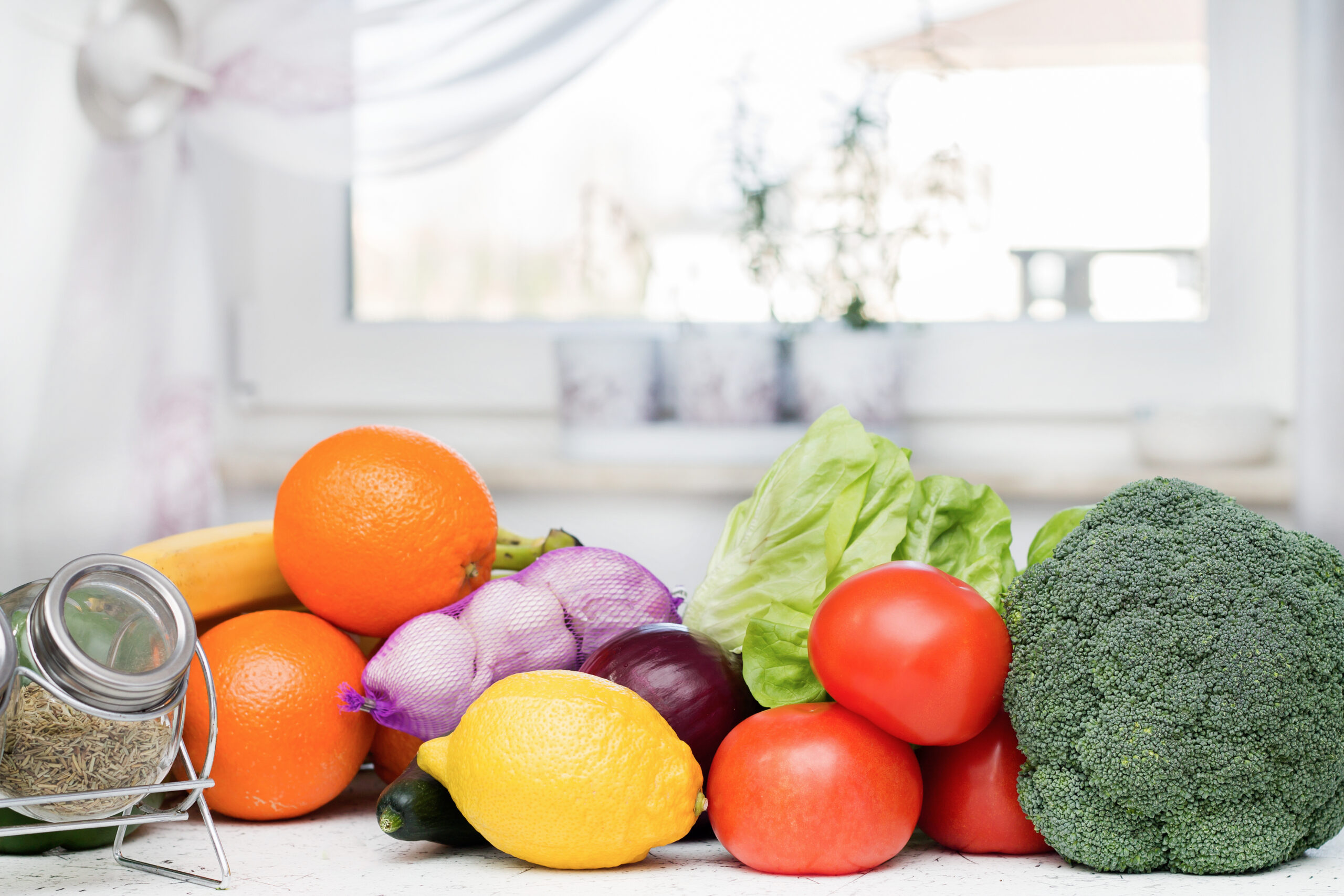 fruit and vegetables laid out on kitchen countertop